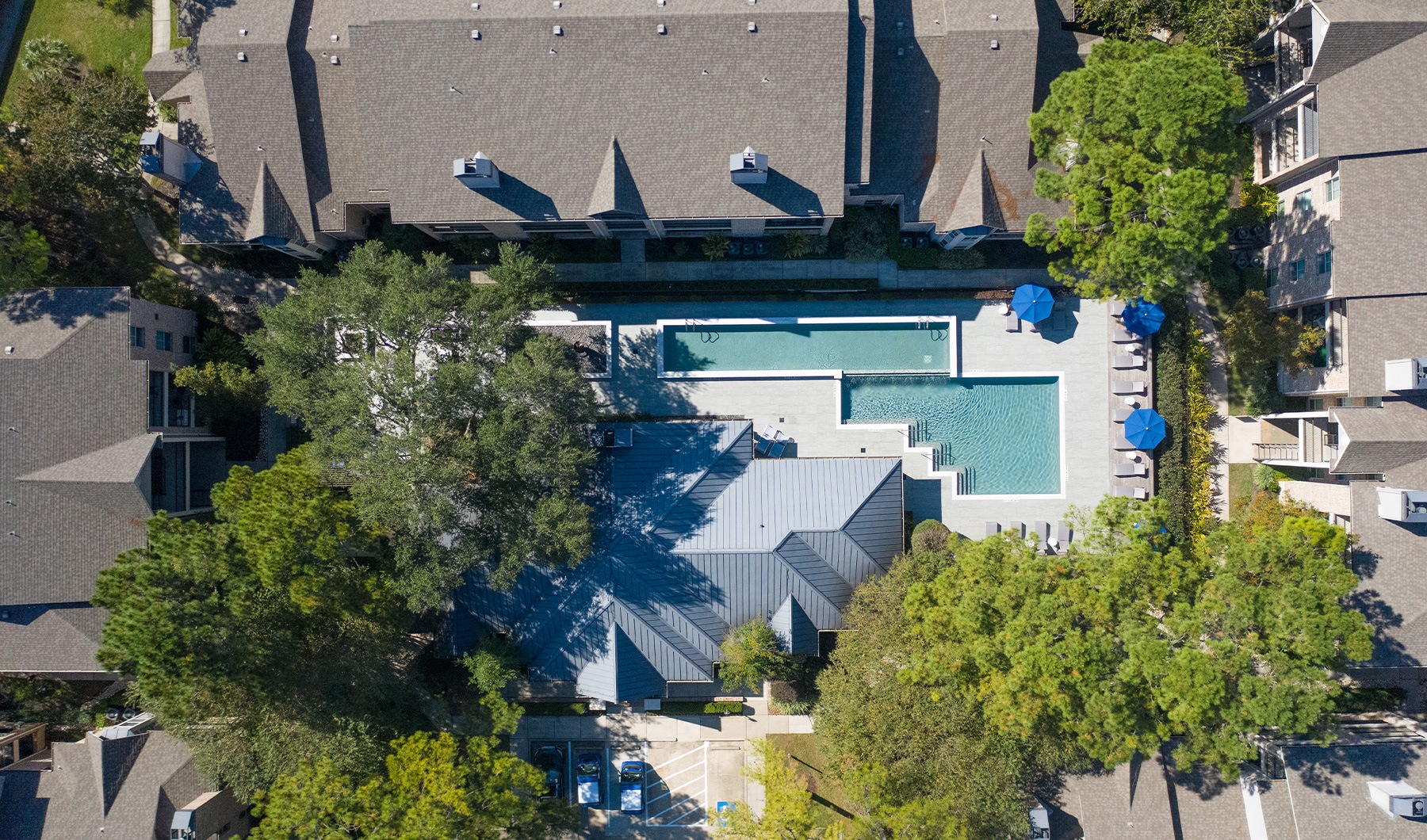 aerial of property pool area showing many trees and spacious walkways